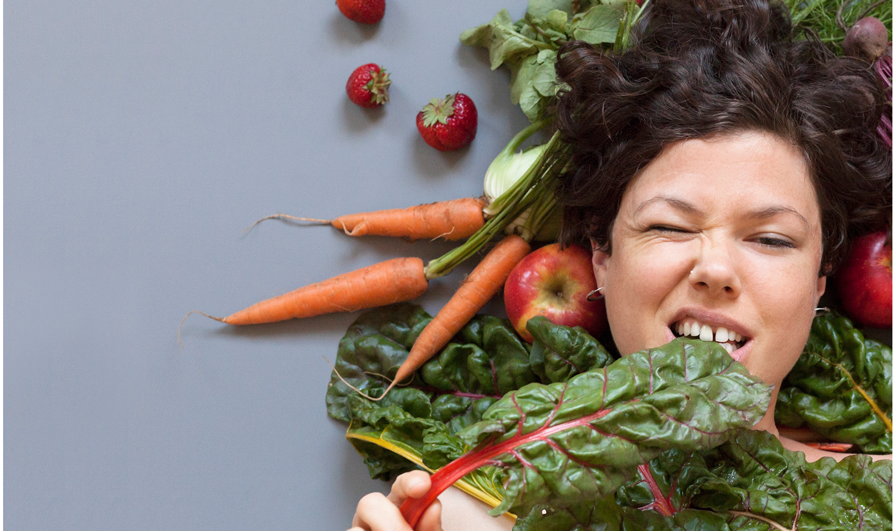 A woman eating vegetables